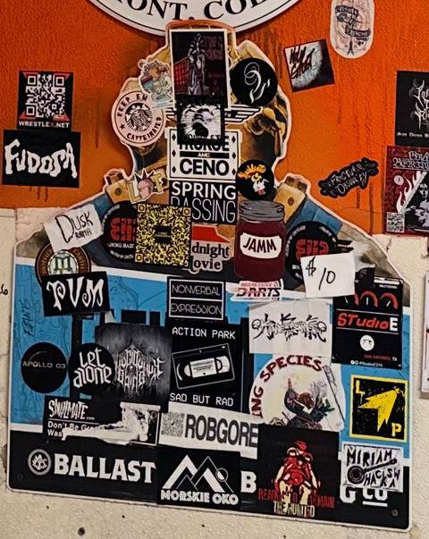 Sticker-bombed Ballast Point sign