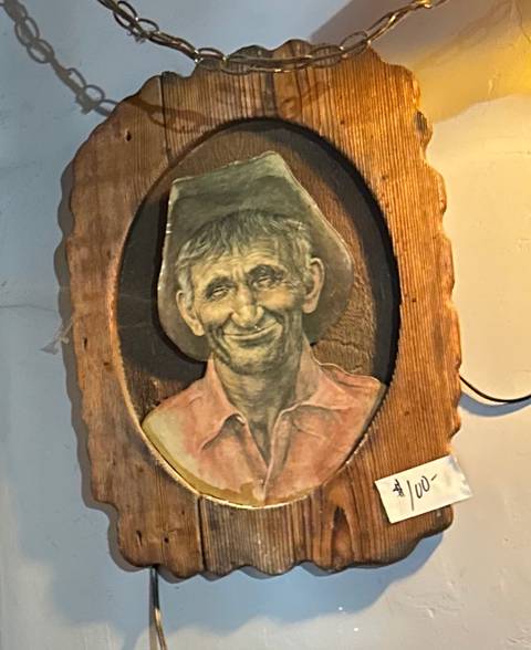 Vintage cowboy portrait on carved wood